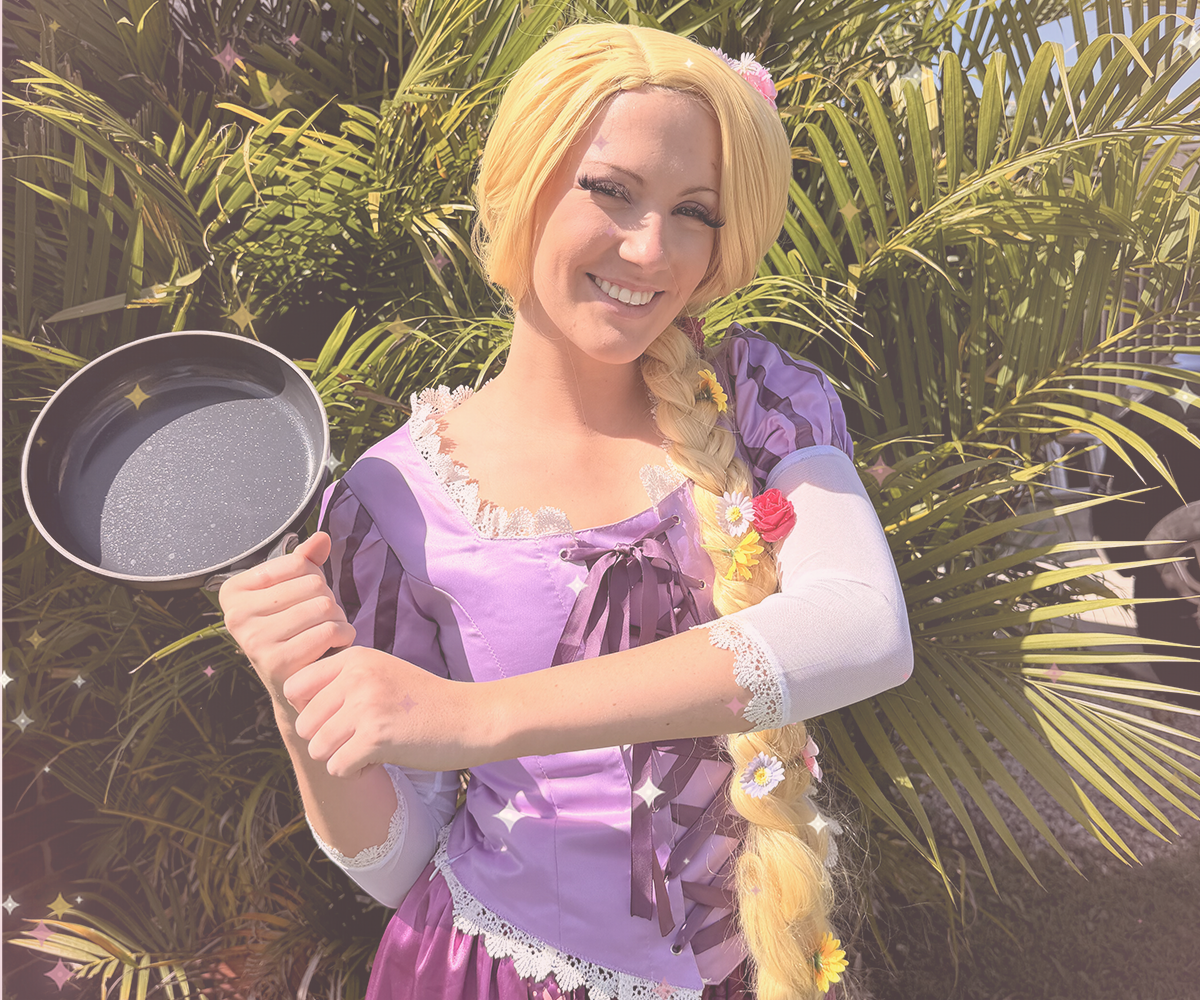 Princess character reading a storybook aloud to seated party guests