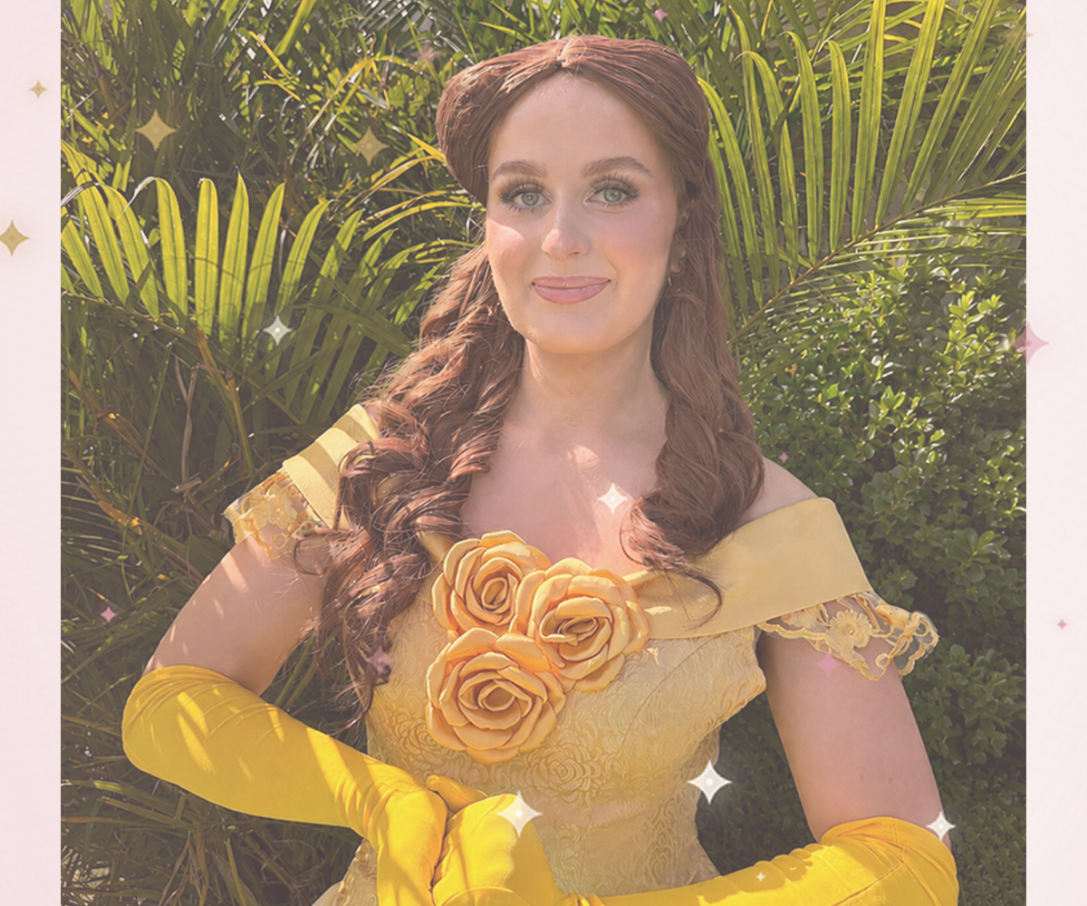 Beauty Princess character performer in a golden ballgown with roses