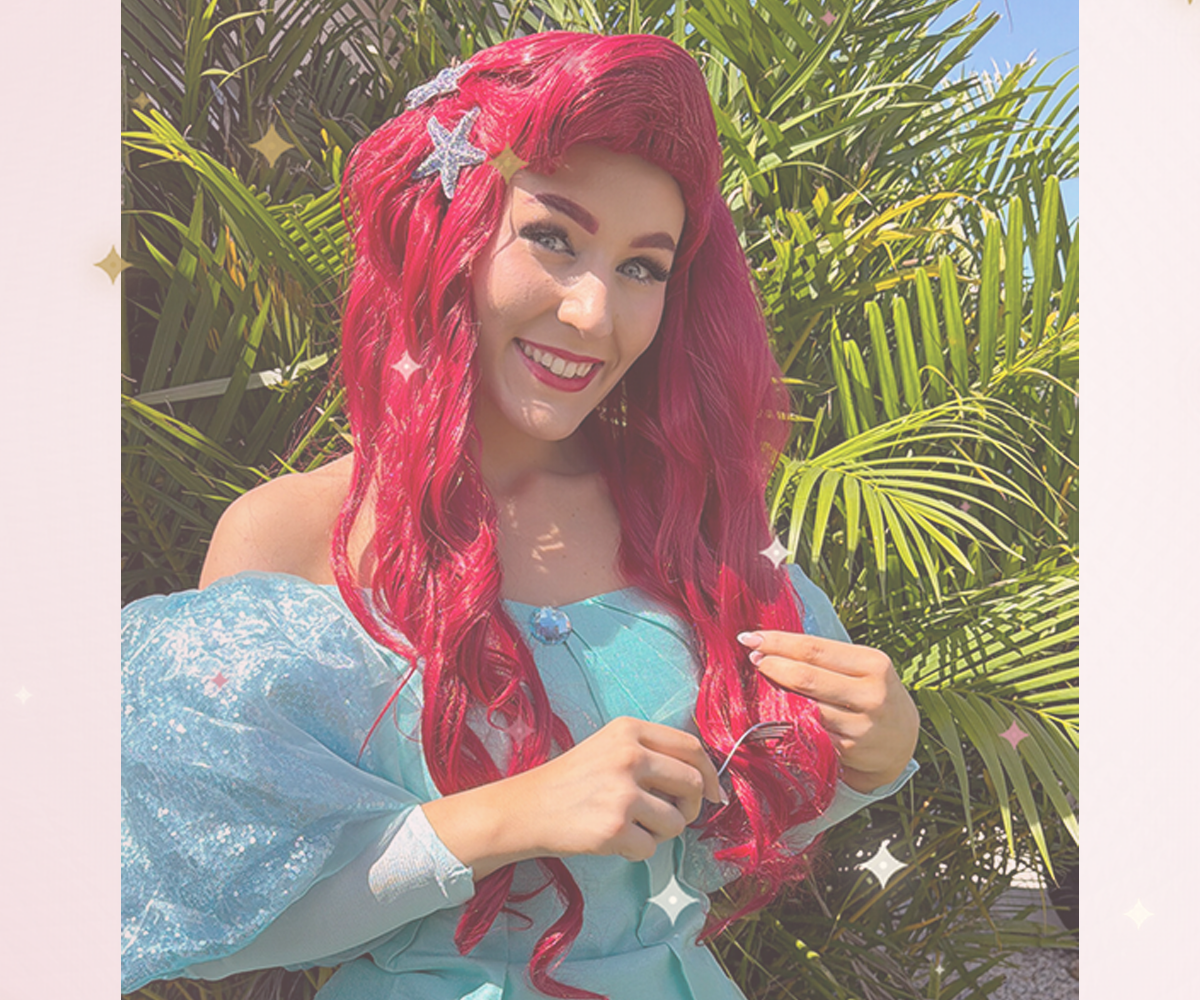 Mermaid Princess character performer with flowing red hair in an aqua gown